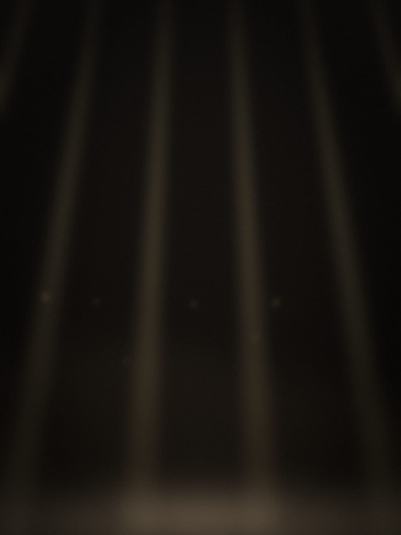 an array of truss-mounted light beams cutting through haze above low fog
